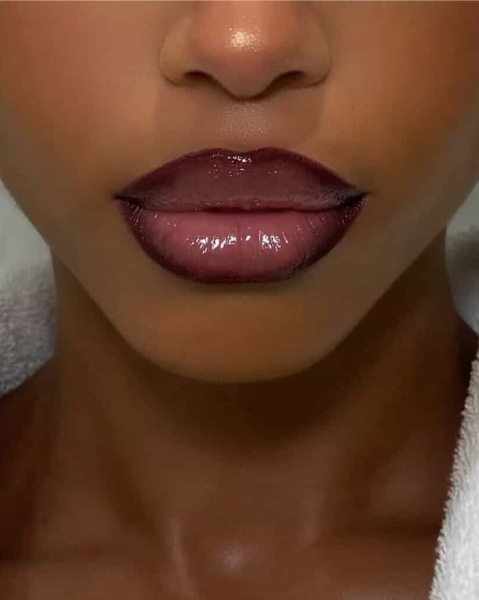 Closeup of Lori Harvey with a lined glossy fantasy lip combo.
